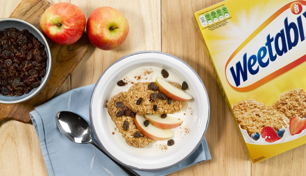 Bol de manzana, pasas y canela con caja de Weetabix Bol de manzana, pasas y canela con caja de Weetabix