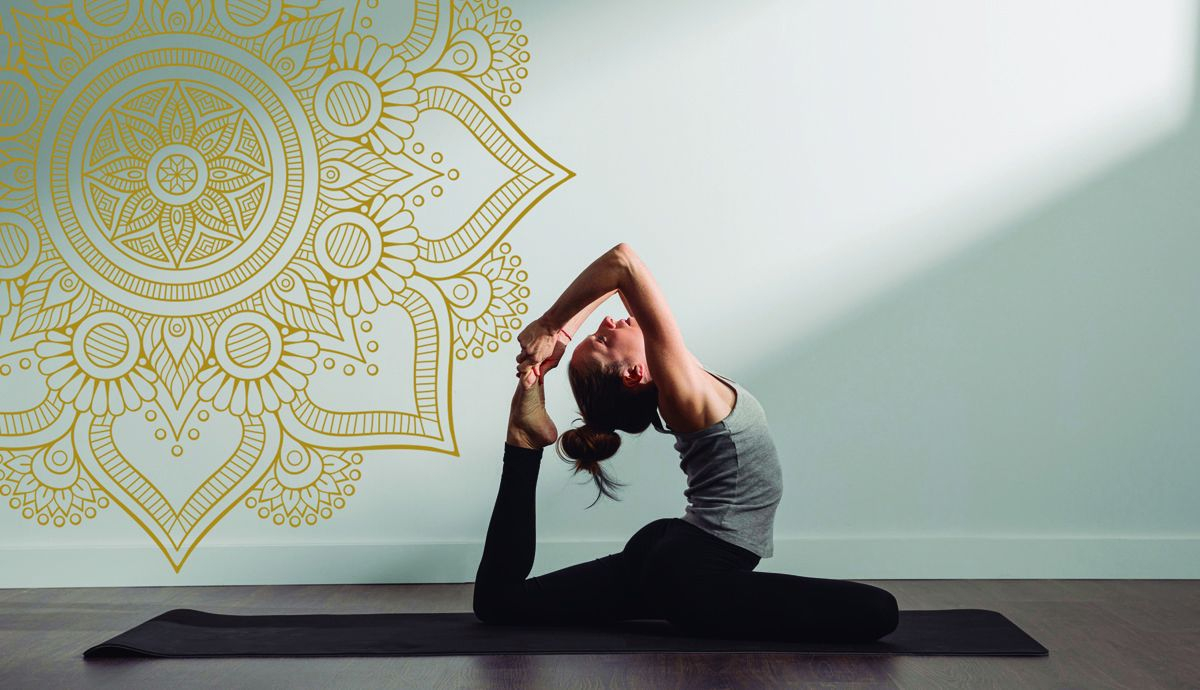 active woman practicing yoga at home